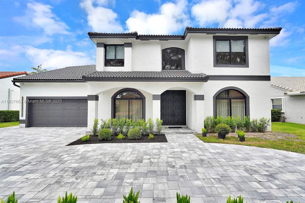 Rare opportunity! The ultra modern residence is situated in Cooper City’s 24-hour gated community, Embassy Lakes. With over 3,000 SF of living space on an 8,261 SF lot, this home features an open-concept layout, modern kitchen with Italian cabinetry, an oversized island, formal living and dining room, and a striking floating glass staircase. The primary suite boasts a free-standing tub, dual sinks, and two custom closets. Additional highlights include an a loft that can be converted into a 5th bedroom , cabana bath , designer light fixtures, floor-to-ceiling impact windows and doors, modern bathrooms , 2 car garage , and a circular driveway. Enjoy outdoor living with a renovated heated pool, covered lanai, fenced yard with astroturf, and proximity to A+ schools and major highways.