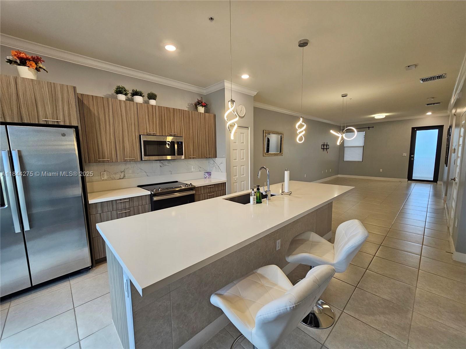 Ultra-Modern Style condo w/ 2 bed/2 1/2 bath w/ stainless steel appliances on the 2nd floor. The building has Elevator Located in the exclusive gated community of Apex at Park Central, Near A+ Schools w/ access to a Resort style club house with all amenities such as a Kids Water Park, Huge Pool, Basketball courts, tennis courts, pool cabanas Gym, Ballroom for Private Events and much more! imagine enjoying your living experience. Unit features an open floor plan w/ a large kitchen island with quartz counter tops. The unit has washer & dryer & Tile floors throughout. Walking Distance to Shopping centers and Banks, etc. Available to move in right away. Internet service included in the rent. Apartment equipped with blinds & smart switches to be controlled with an Alexa device.