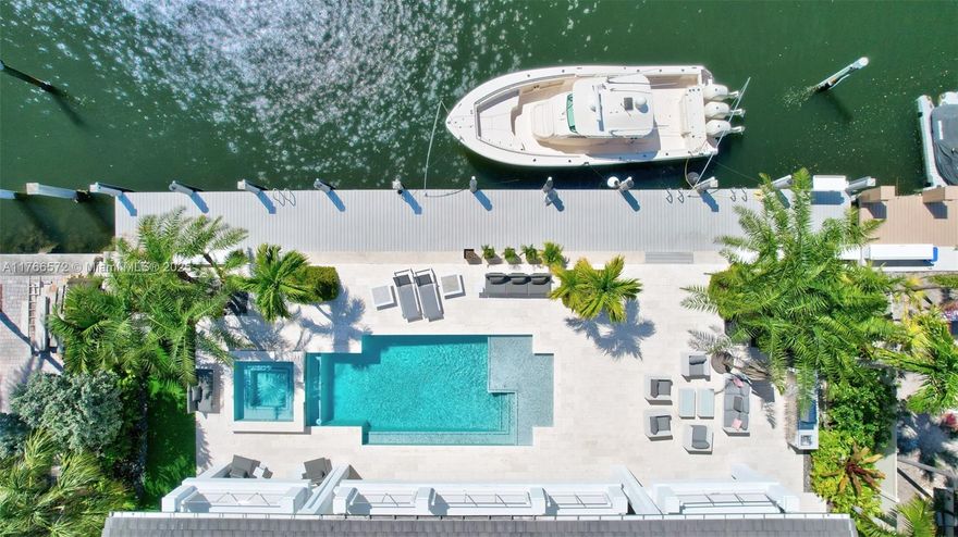 This waterfront Coral Ridge Estates home offers 100 feet of recently dredged deepwater frontage, providing dockage for an 80-foot yacht with no fixed bridges and quick Intracoastal access. Completely rebuilt in 2016, this luxurious residence features dual primary suites, a club room, and exquisite finishes, including Diamanté Thassos marble flooring, custom millwork, and recycled seaglass countertops. The outdoor oasis is designed for entertaining, boasting a heated pool and full-size spa. Additional highlights include a home generator, gas cooking, and a newly upgraded smart home system. A true boater’s dream, this home is surrounded by top schools, parks, restaurants, and shops, just minutes from the beach, and Brightline train station and only 20 minutes from the international airport.