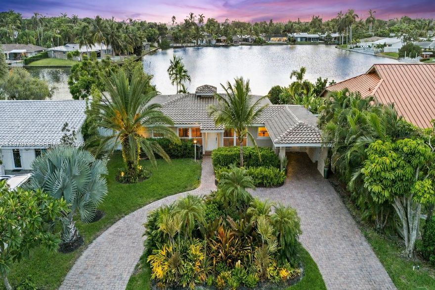 Experience luxurious waterfront living in sought-after Central Corals, just minutes from Fort Lauderdale and the beach. This elegant, move-in-ready lakefront home offers breathtaking sunset views, lush tropical landscaping, and a spacious backyard oasis designed for both relaxation and entertaining.

Enjoy direct access to the lake from your own backyard—perfect for fishing at sunrise, paddleboarding across calm morning waters, kayaking along the shoreline, or windsurfing in the afternoon breeze. Whether you're launching a paddleboard, casting a line, or simply enjoying the peaceful water views, this home delivers the ultimate South Florida lake lifestyle.

Inside, the light-filled open-concept layout features a gourmet kitchen with stainless steel appliances, ideal for both everyday living and hosting guests. Thoughtful upgrades provide peace of mind, including a brand-new roof, updated plumbing and electrical, hurricane impact windows, and elegant plantation shutters.

Wake up to tranquil water views and unwind each evening with spectacular sunsets reflecting across the lake. Conveniently located near top dining, shopping, and cultural attractions, this home offers the perfect balance of waterfront serenity and vibrant South Florida living.