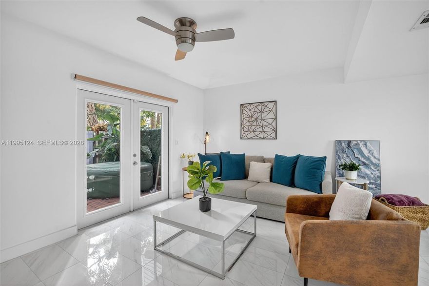 Fully furnished, Beautifully updated 2-bedroom residence nestled along the Middle River in a prime central Fort Lauderdale location.  Lush tropical foliage, privacy walls, and a private patio with hot tub create a serene, resort-style setting with exceptional privacy.  Vaulted ceilings and porcelain flooring enhance the bright, open living space, while impact windows and doors offer peace of mind and energy efficiency.  This home features a spacious primary bedroom with a true master bathroom suite and walk-in shower, ample storage throughout, and a well-appointed kitchen with stainless Whirlpool appliances.  Enjoy access to a community pool within a fenced-in complex with security cameras.  Ideally located just 10 minutes to the beach and downtown Fort Lauderdale, walkable to the nearby entertainment district, and minutes from Colohatchee Park and a local boat ramp.  A rare opportunity to live in a private, river-adjacent setting with unbeatable convenience.