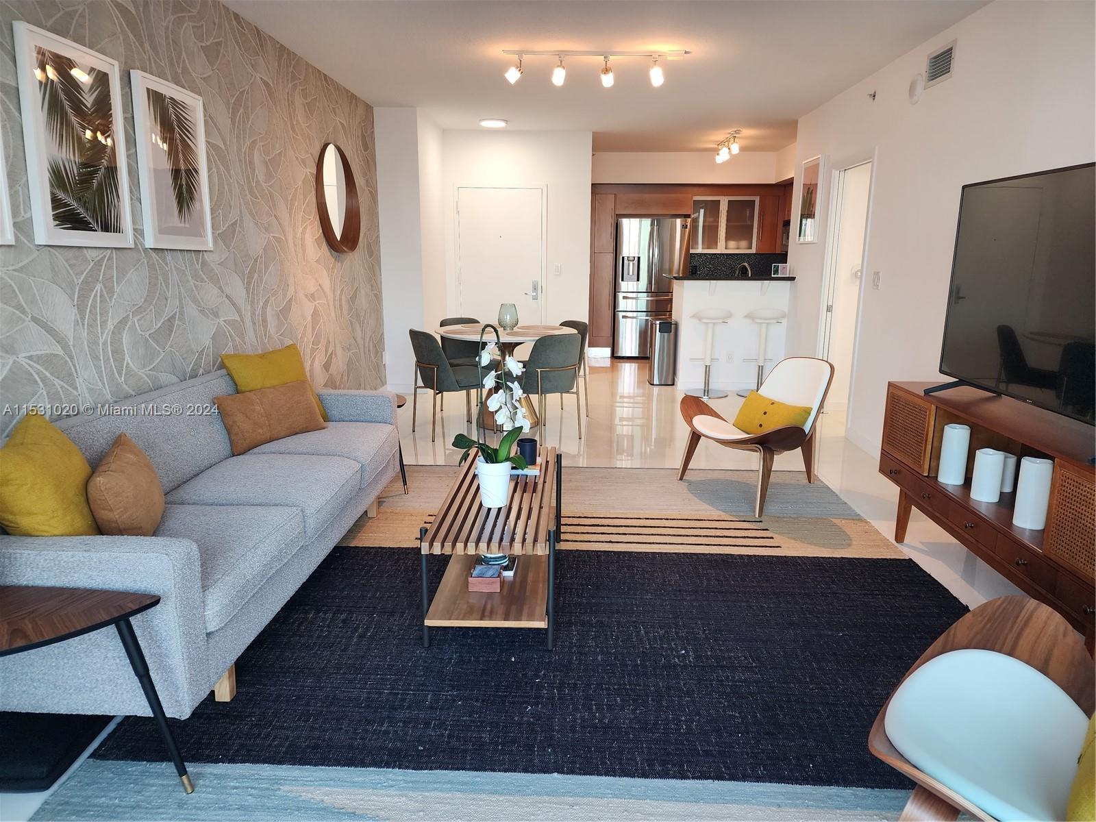 Absolutely gorgeous and upgraded 2 bedroom corner unit on the 40th fl. Stunning water views of Miami's intercoastal and World Famous Miami Beach. This fully furnished condo is carefully designed with tasteful artwork and wall finishes. French Vanilla marble floors all throughout including balcony. Marble bathrooms with new cabinets. Bosch A/C Unit. Italian kitchen cabinets, back splash & granite counter-tops, new refrigerator, dishwasher, washer & Dryer. One Miami Residences is centrally located within minutes to Downtown Miami District, Miami Heat Arena, Bayfront Park, Brickell, Design District, South Beach, MIA Airport, Coconut Grove, Shopping, Restaurants, and much more.