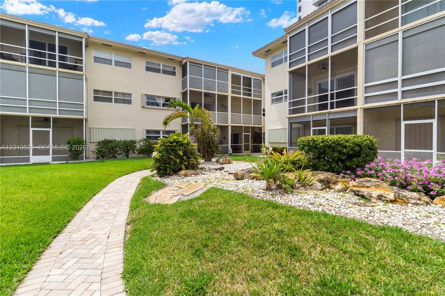 Experience waterfront luxury in this stunning ground-floor apartment, nestled in the coveted Coastal Waterways Coop.  Enjoy your beautiful paradise from your private screened-in porch, perfect for relaxing mornings or alfresco dining. The bright, airy layout features a revamped kitchen, plenty of storage, and an open-concept living area that flows seamlessly into the spacious bedroom with en-suite bath.This gated boutique community offers a tranquil oasis, just steps from Hallandale Beach's best amenities. Stroll to the beach, explore top-rated shops and eateries, or take advantage of nearby attractions like Gulfstream Park and Aventura Mall. With easy access to Miami and Fort Lauderdale airports, this waterfront retreat is perfect for full-time living or a dream vacation home. Don't miss this rare opportunity to own a slice of paradise!
