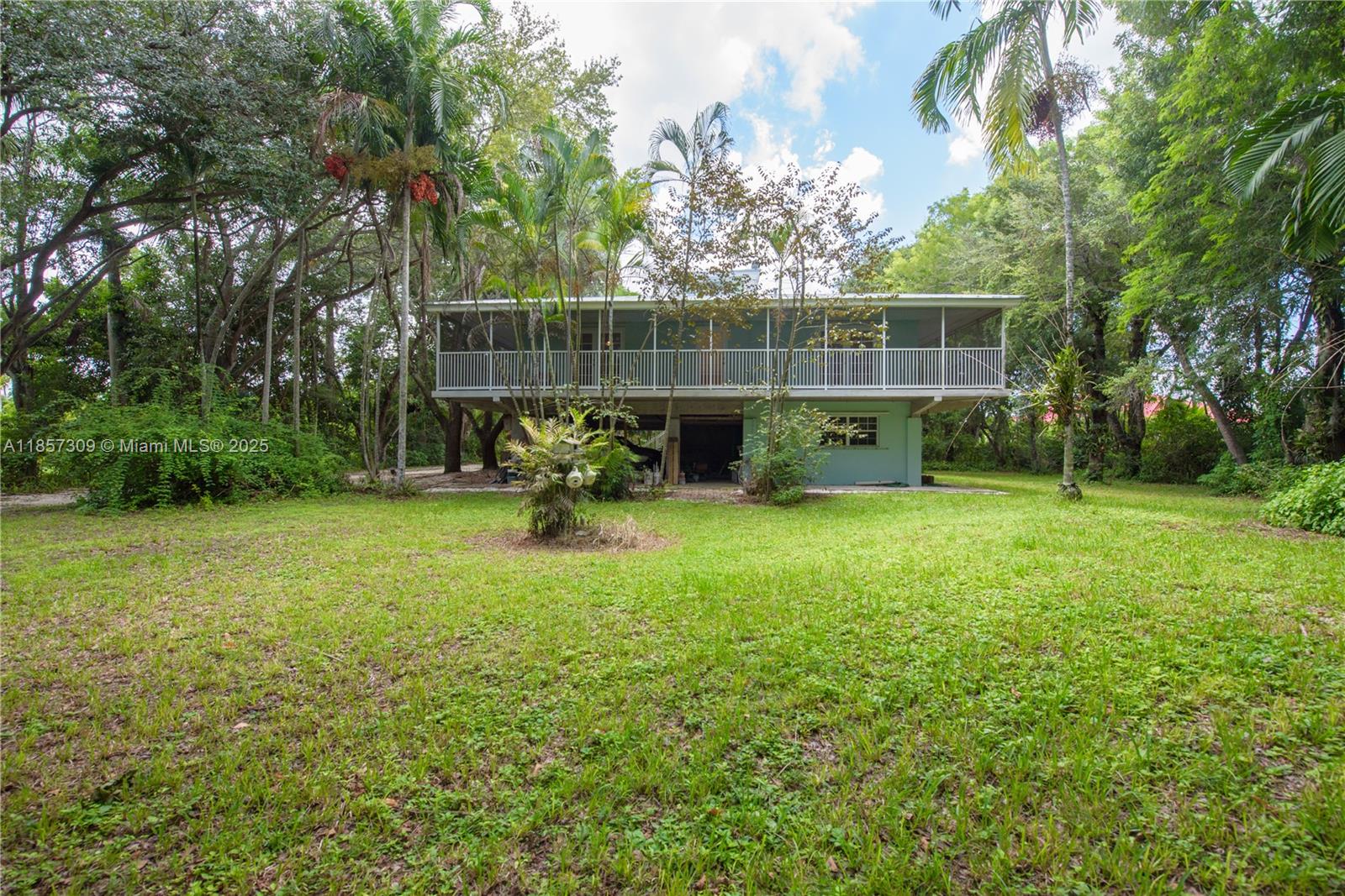 Tropical oasis with New metal Roof, wrap-around screened porch, and 4-carport parking! Bright interior features tile & laminate floors, white kitchen with gas stove, pantry, and spacious great room. French doors open to porch from multiple bedrooms. Master retreat offers walk-in closet and private bath. Down stairs is a Studio/office with full bath—ideal for guests or workspace! Start your own Orchid business with 3 shaded Orchid houses with water for misting your beautiful flowers. Lush landscaping with mango, lychee, oak & mahogany trees. Includes mower, trailer, freezer, central vac, and more! PROOF OF FUNDS AND/OR PRE-APPROVAL LETTER REQUIRED PRIOR TO SCHEDULING A SHOWING OF THE PROPERTY!