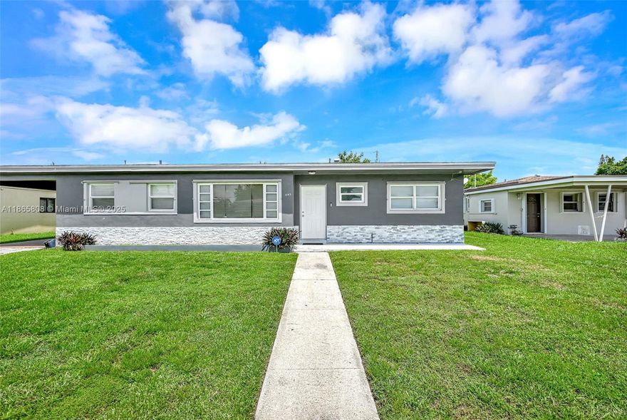 Spacious 3BR/2BA home on an oversized 8,250 SQFT Lot! Features include a modern kitchen with quartz counters, stainless steel appliances, and full laundry room. Tile floors throughout with wood laminate in the master, which offers a shower bath and dual closets. Enjoy separate living, dining, and family rooms plus a huge fenced backyard perfect for entertaining. Carport parking, updated baths (tub in 2nd), and convenient location near Hard Rock Stadium complete this move-in ready gem!!!! PRICE REDUCTION $20,000.  Priced to sell!!!