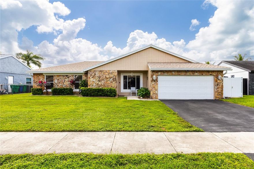 Beautiful home in one of Cooper City’s most desirable neighborhoods! This spacious layout features vaulted ceilings, a formal living room, and a dining area with a breakfast bar overlooking the kitchen. The bright Florida room opens to a pool and large backyard with peaceful lake views—ideal for relaxing or entertaining. Upgrades include a 2023 roof, 2025 pool pump, 2022 water heater, 2019 A/C, partial impact windows, and window shutters. No HOA and walking distance to Griffin Elementary, with top-rated Pioneer Middle and Cooper City High nearby. Close to family-friendly restaurants, parks like Tree Tops and Flamingo Gardens, and the Hard Rock for dining and events.