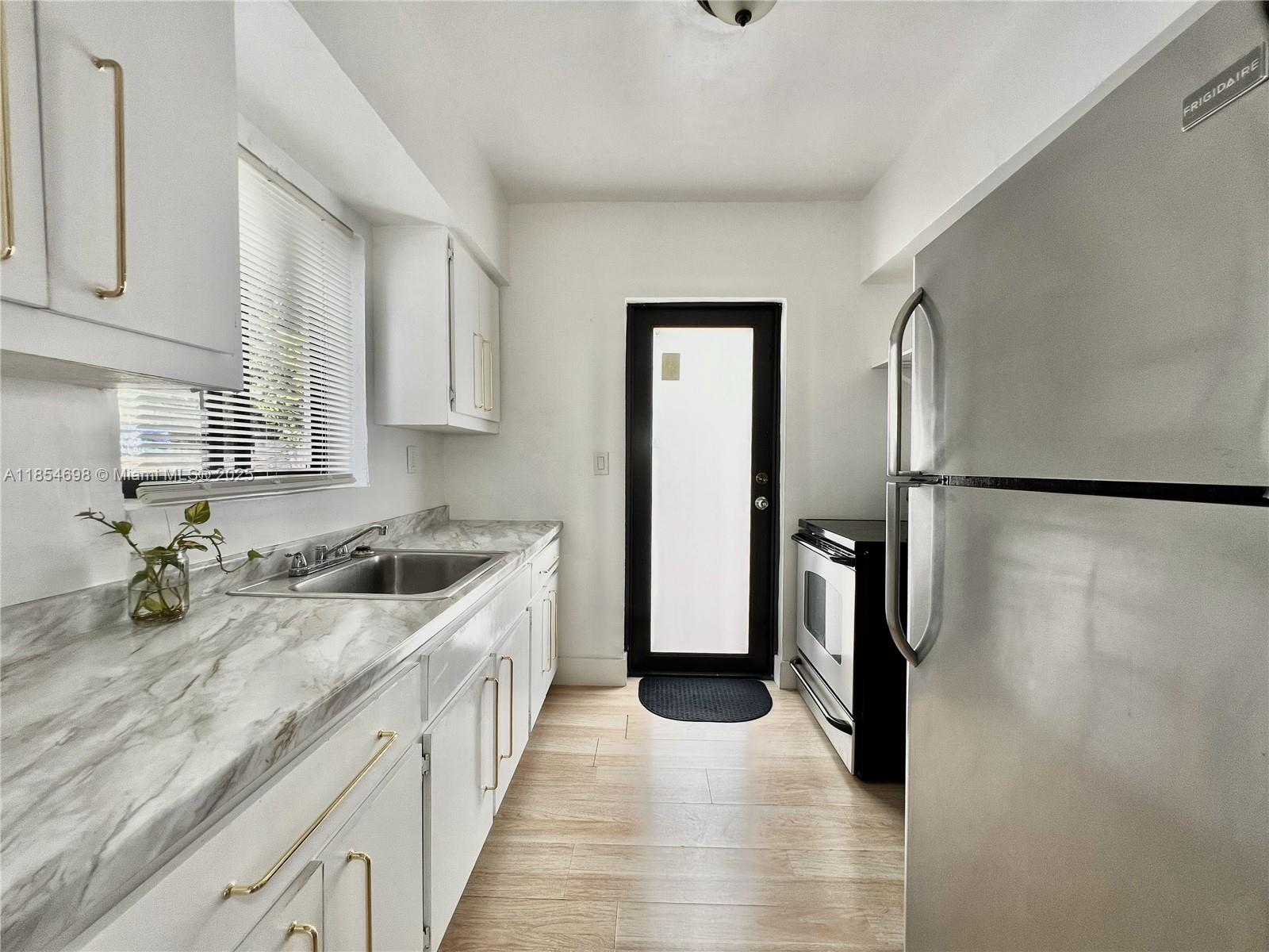 Stunning and highly sought-after corner 2-bed, 1-bath unit just a 10-minute walk to the beach! This bright and airy back-unit offers extra privacy, no neighboring buildings blocking your view, tons of natural light, high-impact windows and doors, cold central A/C, vinyl flooring, refrigerator, electric range, and a spacious private backyard perfect for peace and relaxation near the beach. We present all offers.