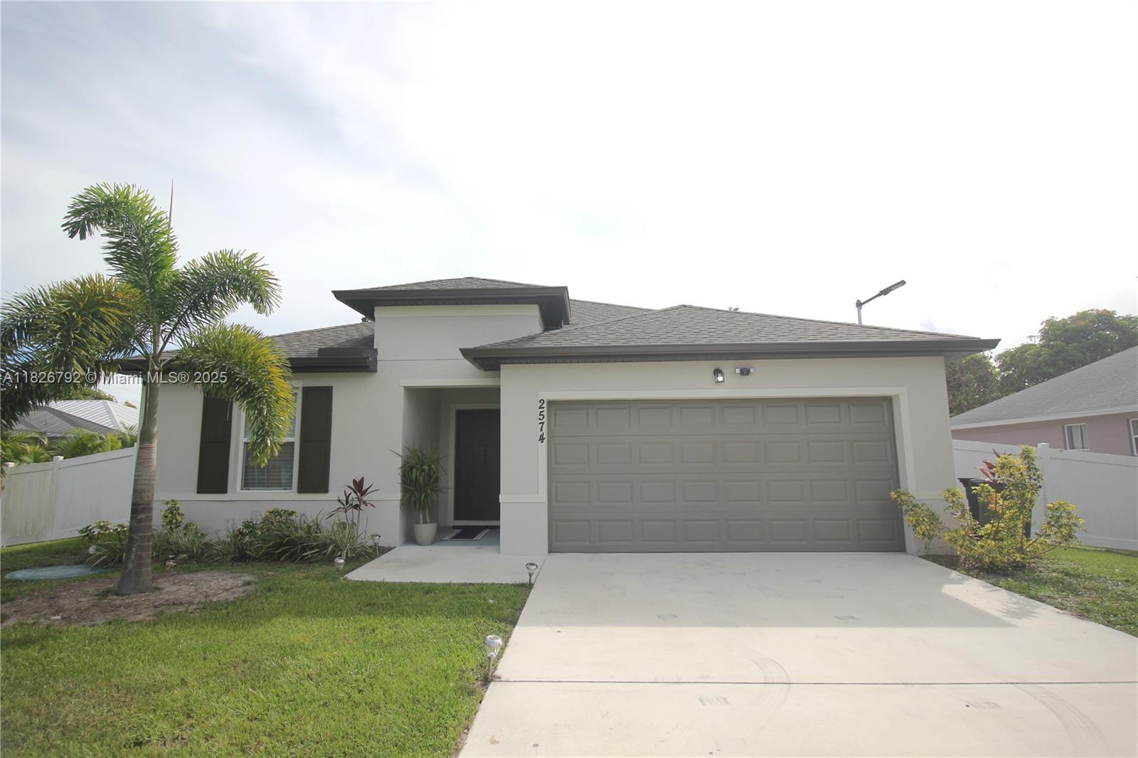 Discover this stunning new construction located in a peaceful neighborhood! This beautiful property features 4 spacious bedrooms, 2 modern bathrooms, and sits on an impressive 10,000 SqFt lot offering endless possibilities. Move-in ready and semi-furnished, kitchen with granite countertops, a brand-new backsplash, and all-new stainless steel appliances. Enjoy the convenience of a two-car garage with an automatic door, a long driveway providing ample parking space, plus wide side entrances perfect for storing your RV or boat. The large backyard is fully fenced for privacy and security, with plenty of room for a pool, has a cozy fire pit. Perfectly located just minutes from the Turnpike, 20 minutes from the beach, and close to supermarkets, shops, gyms, urgent care, and restaurants.