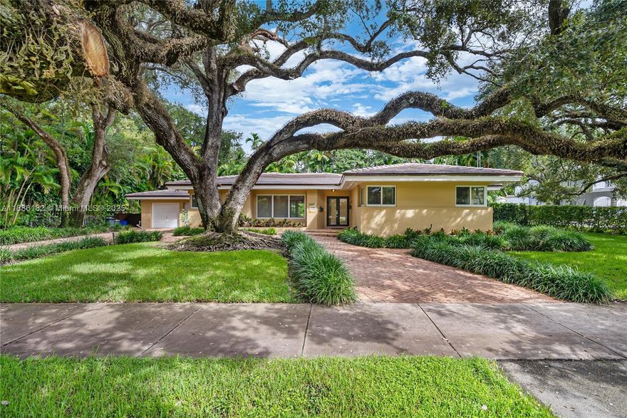Spacious and comfortable South Gables home with dramatic live oak welcoming guests. Terrific floor plan - spacious 3 bedroom + den, 2 bathrooms, 3,073.89 sqft. Features an open living room, dining room and very large Florida room. Lovely finishes include crown moldings, recessed lights, and French doors. The eat-in kitchen and bathrooms have been remodeled with marble, wood cabinets & granite. Home has impact windows and rolladen shutters for FL room. 2 car garage with laundry, sink, and gardener bathroom. This home sits on a massive 15,000 sq. ft. lot. The lush, private yard has a covered patio with Chicago brick walkways and plenty of grass for kids to play around on.
