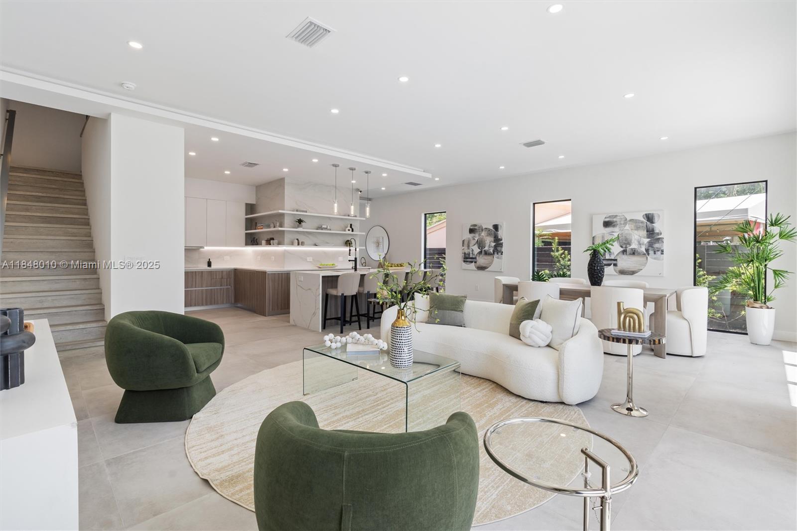 Experience modern living in this elegant Coral Ridge residence, ideally located in the heart of Fort Lauderdale. Spanning 4,852 sq ft of total area, this home features three spacious bedrooms, four bathrooms, a den, full-size laundry room, and high ceilings that amplify natural light and openness. Porcelain floors and quartz countertops add refined elegance, while the chef’s kitchen includes Dacor and Bosch appliances. Multitrack sliding doors open to a private pool and terrace, creating a seamless indoor-outdoor feel. The rooftop terrace offers a summer kitchen, jacuzzi-ready hookups, and sweeping sunrise-to-sunset views. Includes a 2-car garage and parking for 3 additional vehicles. NO HOA!