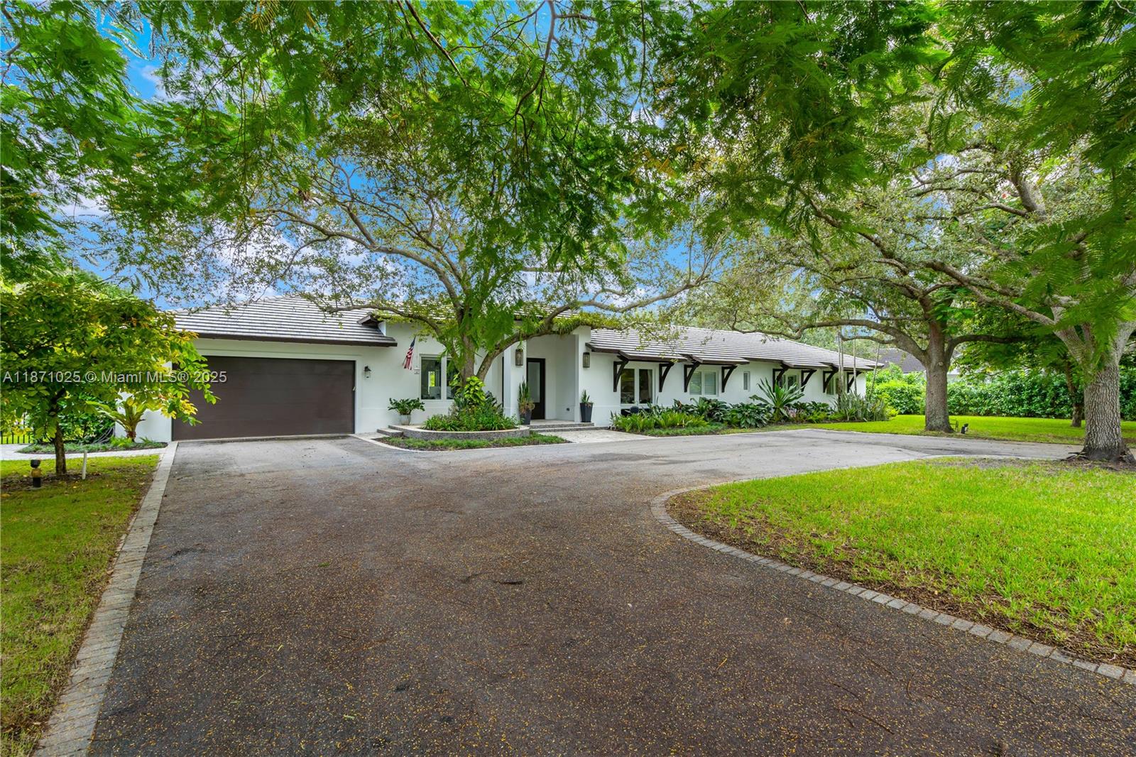 Step into this luxurious 2016 custom-built timeless design home, set on a serene acre lot. With 5 bedrooms, 4 bathrooms, and a stunning backyard featuring a pool, water fountain, and outdoor shower, this home is perfect for entertaining. The expansive patio has 12-foot ceilings, while the open interior with 10-foot ceilings fills the space with natural light. The home includes a 3-car garage, second laundry area, and automation for lighting, shades, and built-in ceiling speakers. Shaded by mature oak trees, the yard has space for any activity, making it ideal for hosting. Engineered for strength by a forensic structural engineer, this home offers exceptional hurricane protection. With its quiet neighborhood and ample space, it’s the perfect setting for creating lasting family memories.