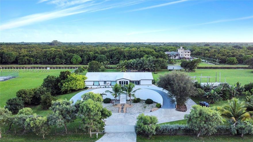 Stunning 2019-built Redlands estate on nearly 4 acres with 11,000 total square feet.  It offers the ultimate blend of luxury, privacy and self-sustainability. Situated on a quiet street, this hurricane-proof home with concrete roof features 6 beds, 6 baths, high 15-ft ceilings, polished concrete floors, gorgeous natural light upstairs and a massive underground level garage that accommodates up to 10 cars! Concrete roof with 60 solar panels, 20KW battery backup, multiple EV chargers, fertile farmland, fruit trees and a state-of-the-art underground bunker. Located 25 ft above sea level on a quiet street near horse trails. Rare opportunity for safety, independence and resort-style living in the Redlands. Seller has already constructed reinforced concrete walls on the deck for a future 40×20 ft pool with spa—simply complete the final build to customize your own resort-style oasis.