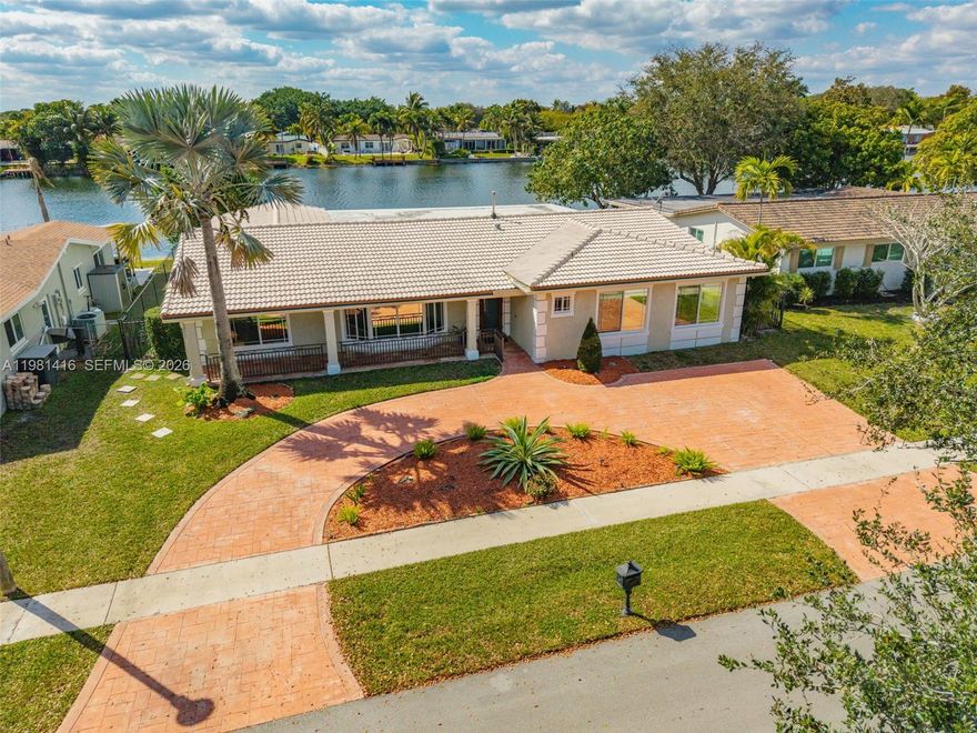 This charming house is great for a large family or for entertaining! Enjoy cooking in this gourmet kitchen, with double ovens, gas and electric range. The meticulously designed space features generous granite counter top, custom lighting and abundant cabinetry. Inside, the bright and spacious layout provides plenty of room for everyone. It boasts large windows, a formal living room, family room, and a dining area, laundry room, all designed with an open-concept layout. Hurricane windows and doors. The backyard has a beautiful bright and spacious deck with a spectacular view of the lake. This popular Pembroke Model on the Lake and on a great street is a short walking distance to a well-kept playground which is great for neighborhood get togethers or for the children to have a safe place to play.  Conveniently located near shopping, dining, hospitals and major highways. This home blends comfort, lifestyle and location. This is truly the best-priced home in the area. NO HOA and NO rental restrictions make this a perfect home for end users or investors.  Don't miss this rare find! Easy to show.