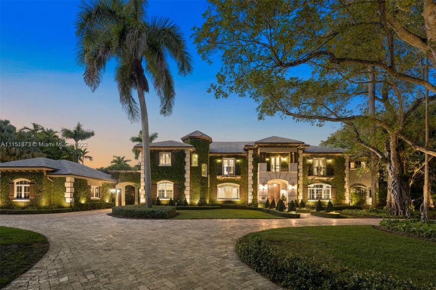 Captivating and elegant 9,671 Sq. Ft. residence with 6 bedrooms, 6 full and 1 half baths featuring exquisite amenities and very private, spacious living. Luxury abounds throughout the home, with high ceilings, clerestory windows, interior wrought iron balcony railings and beautiful chandeliers. The open concept kitchen has top-of-the-line appliances and flows to the breakfast area, living room and covered terraces. The impressive main suite offers a spa-like bath with a spacious shower, jacuzzi and 2 walk-in closets.  The home also features a billiard room, bar, gym, formal dining room with a wood-burning fireplace, elevator and an additional winding iron staircase. The gorgeous resort-like grounds include a putting green, gazebo with a summer kitchen, pool with a swim up bar and jacuzzi.