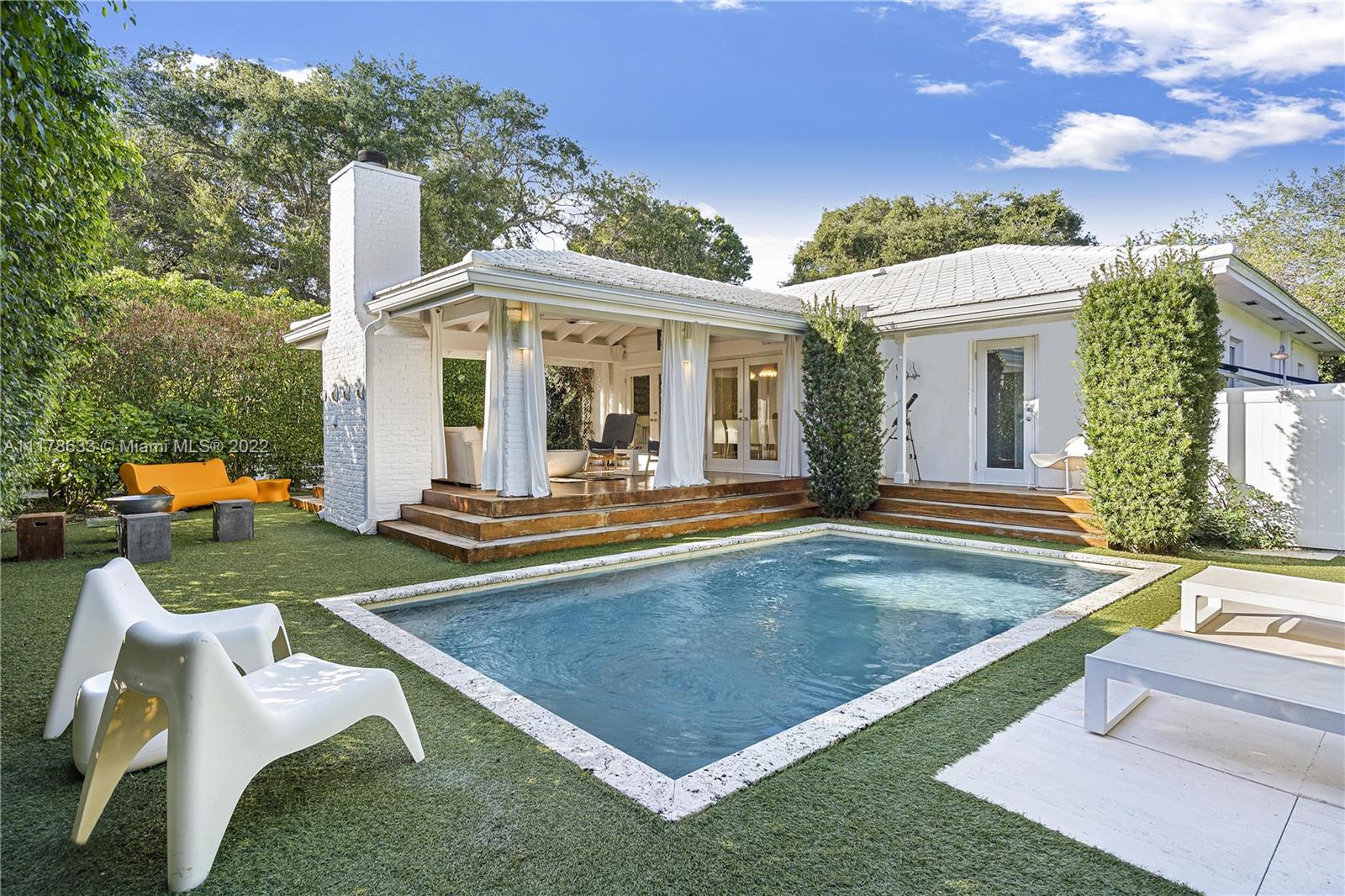 Idyllic oasis located in sought after East Miami Shores. Short walk to sunsets at bay and to golf at country club. 3 bedroom, 2 bath pool home with gated courtyard entry. Light, open and airy Bahamian style features 13 ft beamed wood ceilings and whitewashed wood walls, wood and marble floors, custom built ins, designer fixtures and finishes. Open rustic modern kitchen, tucked away primary bedroom with luxury spa bathroom, dressing room and patio area. Outdoor kitchen and dining room, fully covered wood patio with outdoor fireplace, TV, and sound system perched over modern pool. Hurricane impact windows and doors, alarm system, Tesla charing station, circular driveway, privacy fenced and landscaped yard. Also available furnished or partially furnished if preferred.