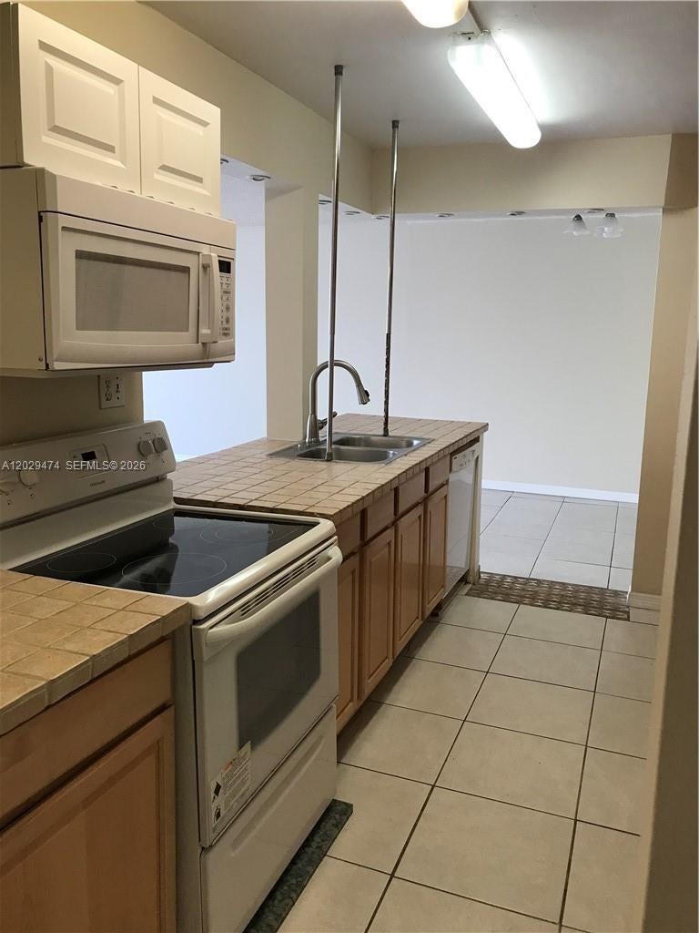 Photo of 7081 Environ Blvd #242, Lauderhill, FL 33319 (MLS # A12029474)