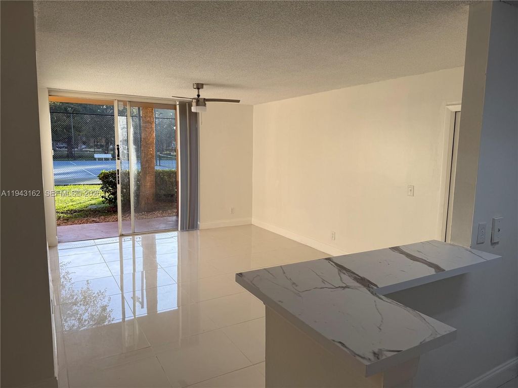 Photo of 10773 Cleary Blvd #104, Plantation, FL 33324 (MLS # A11943162)