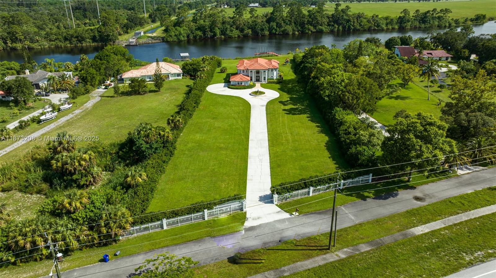 Oceanfront paradise with 8 bedrooms, 5,000 sq. ft. of living space, and nearly 2.5 acres of land. The grand entry with a sweeping staircase opens to a spacious living room featuring a gas fireplace, floor-to-ceiling windows with stunning water views, and custom built-ins. At the heart of the home, the chef’s kitchen connects the breakfast nook and oversized dining room. Warm wood cabinetry, granite countertops, a custom backsplash, two breakfast bars, and stainless steel appliances—including a 6-burner gas stove with pot filler—create the perfect culinary space. The central island offers an additional sink, storage, and wine cooler, blending function and elegance throughout.
