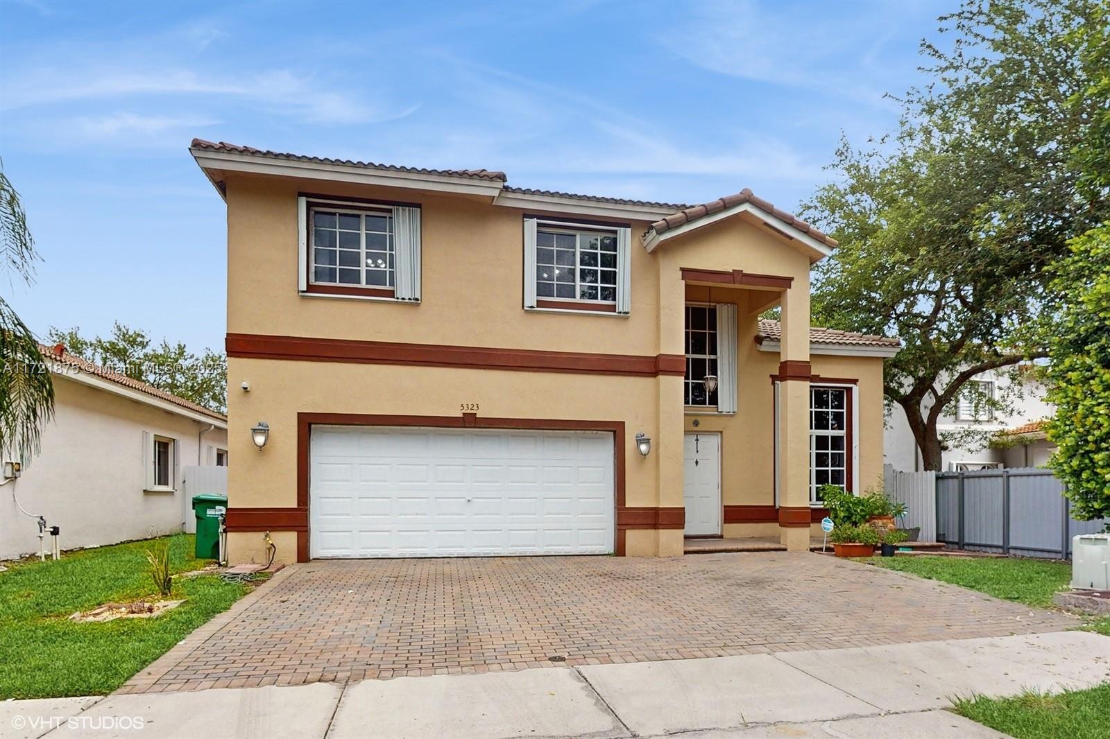 The Happy Home-Located on a quiet cul-de-sac within Doral Gardens,a gated community. Spacious 2 Story home HOA (Only $315.00 Monthly), Built 2000. 4 Bedrooms 3 full baths. Atractive "split floorplan" for multi-generational lifestyle. (Upstairs-3 bedrooms 2 baths Downstairs- One bedroom 1 full bath.) 2 car garage, Updated kitchen, counter seating. Food & butlers pantry. Laundry room, Lots of storage space throughout. Natural light and high ceilings fill this home with great energy. Full storm protection. Great floorplan and location. Well maintained, home is ready for you to enjoy it is (TURNKEY & MOVE-IN READY!) Private back yard with covered terrace enjoy as-is or build a pool ! Ample parking for family and friends.