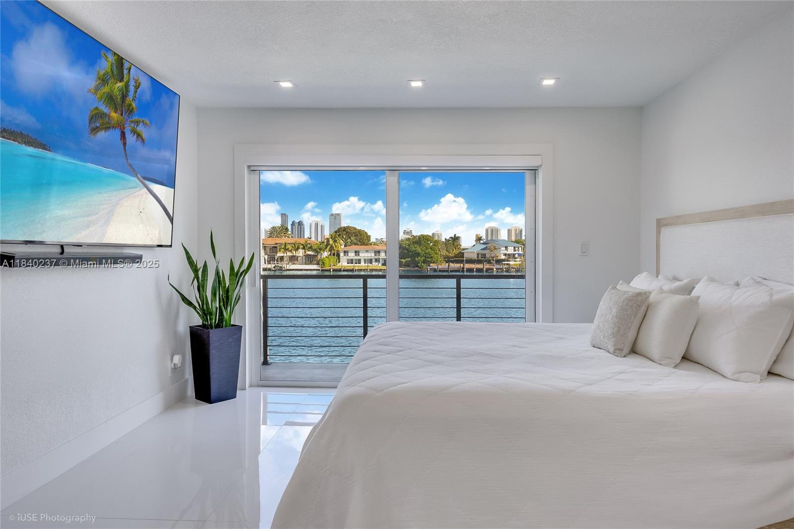 Modern townhouse offering breathtaking water views across Maule Lake with a deed perpendicular dock that fits up to a 40ft boat with direct ocean access and no fixed bridges. This fully renovated, modern beach house provides a functional split-level layout ideal for entertaining. Selling fully furnished and move-in ready, this house features sleek 48 by 48 Italian porcelain flooring, black stainless-steel appliances, impact windows & doors, and a laundry area conveniently located on the upper level. The primary suite is complete with a custom walk-in master closet and panoramic water views. Brand new roof was just completed June 2025 and the special assessment has already been paid in full.