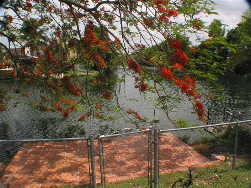 Lakefront town home style 2 bedroom one bathroom, central air, new impact windows, newer barrel tile roof, larger lot and fenced backyard, tile and terrazzo flooring, new kitchen, large rear patio area, fenced backyard and dock w/mango tree no maintenance fee or condo board, fee simple
