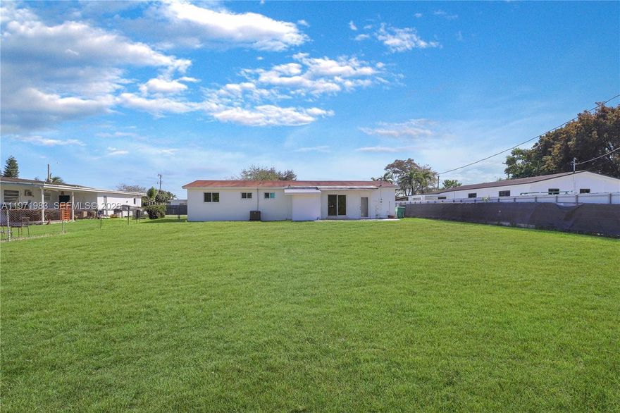 Discover a rare gem in the heart of Miami with this move-in-ready, 3-bedroom, 2-bathroom residence situated on a massive 15,000 sq. ft. lot. This home offers unparalleled space and privacy, featuring an expansive interior layout highlighted by a fully enclosed, air-conditioned back living area that significantly increases functional square footage. Recent high-value upgrades include brand-new hurricane-impact windows and doors, backed by a transferable warranty for ultimate peace of mind. Freshly painted and professionally cleaned, this property is perfectly primed for a new owner to move right in or capitalize on the incredible potential of the oversized lot.