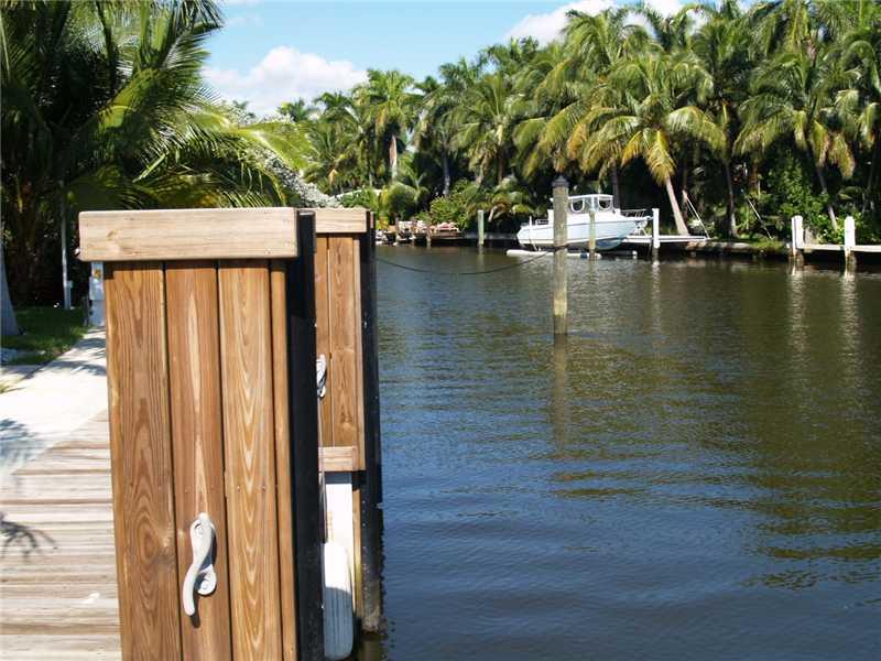 WATERFRONT TROPICAL RETREAT WITH 129 FEET OF WATER FRONTAGE AND PRIVATE DOCK, IN GATED COMMUNITY OF BELLE MEADE. THIS HOME HAS BEEN RECENTLY REMODELED WITH 4 BD 3BA LARGE MASTER SUITE WITH HIS/HERS SHOWER, OVERLOOKING THE WATER, LARGE POOL WITH TIKI HUT &  BAR AREA.  ALL IN A GATED LOT WITH CIRCULAR DRIVE WAY, KOY POND,LUSH LANDSCAPING. CENTRALLY LOCATED MINUTES TO THE DESIGN DISTRICT, DOWNTOWN, MIAMI BEACH, BAL HARBOUR & ALL THE ENTERTAINMENT THAT MIAMI HAS TO OFFER. THIS IS AN UP AND COMING AREA