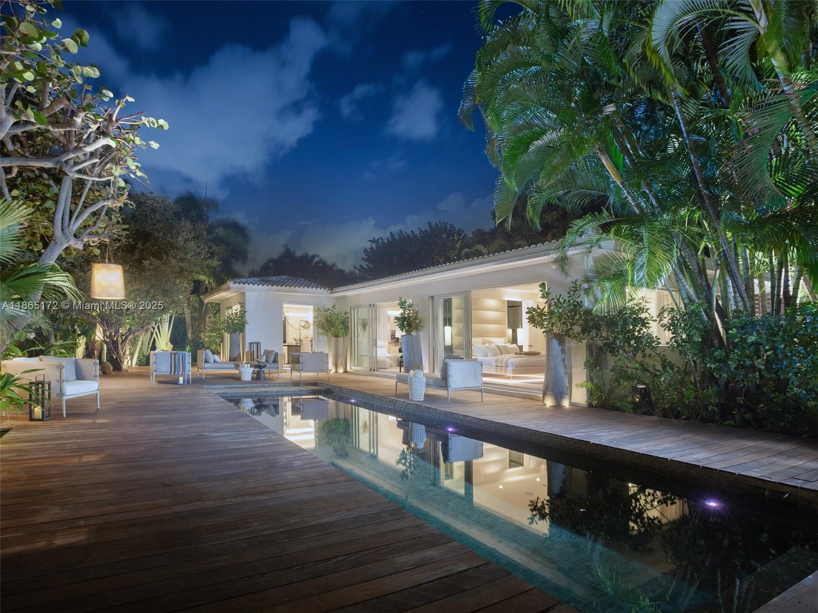 Set on a 10,964sf lot, this 3-bed, 3-bath Miami Beach pool home is a tropical sanctuary, seamlessly blending indoor and outdoor living. The open floor plan features a sleek kitchen with hidden hardware, and expansive living areas that flow effortlessly to the patio and heated pool. Each bedroom suite is designed to be both elegant and cozy, providing a serene escape. A dramatic Balinese-carved root fountain anchors the outdoor oasis and lush landscaping create a resort-like atmosphere, while natural materials and updated finishes add a contemporary, tranquil feel to the home. Just steps from the sand, scenic boardwalk, and Lincoln Road, the home is near world-class dining and nightlife at Faena, Edition, 1 Hotel, SoHo House, and more.