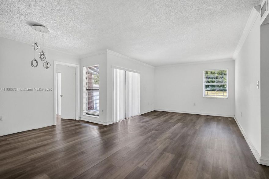 Lovely ground-floor corner unit featuring 3 bedrooms and 2 bathrooms. Recently updated with new vinyl floors and a refreshed kitchen, this condo offers a spacious and inviting layout. The large primary suite includes a walk-in closet, en suite bathroom, and private access to the outdoor patio. Enjoy a mix of covered and open-air space, plus the convenience of your own laundry room. The community provides 24-hour guard-gated security along with amenities including a pool, tennis courts, and serene landscaped views. Centrally located just minutes from major highways, Miami International Airport, and FIU, this home combines comfort, convenience, and value.