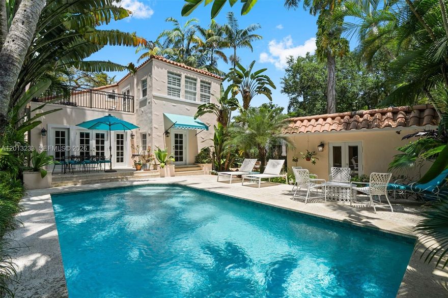 A private retreat blending timeless Old Spanish charm, this two-story home is framed by lush greenery and mature palms, creating a serene and private setting. The main residence features 3BD/3BA, with a warm, light-filled interior that includes a cozy living room with a classic fireplace. The chef’s kitchen features marble countertops, a spacious island, a wine cooler, and direct access to the backyard. The primary suite provides a peaceful escape with its own private balcony. Outdoor spaces are designed for seamless indoor-outdoor living, highlighted by an expansive entertaining patio and a heated saltwater pool. A detached 1BD/1BA guest house with a kitchenette offers a comfortable space for guests or extended family. Ideally located in Coconut Grove, the home is just minutes from CocoWalk, waterfront parks and marinas, dining, and top-rated schools.