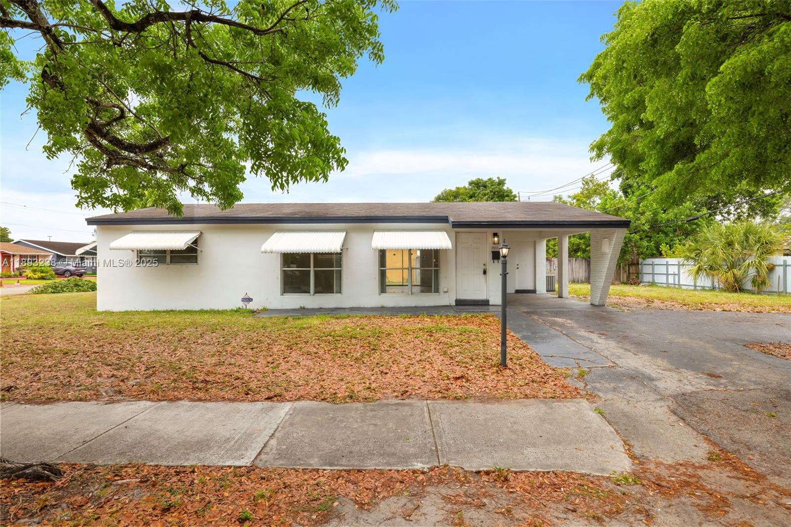 Exceptional Corner Lot Opportunity in Hollywood! This charming 3-bedroom, 2-bathroom single-family home sits on a spacious 7,528 sq ft corner lot—offering exceptional privacy and space for expansion or a pool. The 1,250 sq ft interior features a practical layout with ceramic floors, and new wood floors in the bedrooms, remodeled bathrooms, new roof in 2018, first-floor entry, and a utility/laundry room. Key Highlights: • Corner Lot: Extra space for outdoor living, parking, or customization. • Solid Build: Concrete block with central A/C, covered driveway, and patio. • Great Value: with new kitchen cabinets, bedroom floors, new bathrooms, new roof in 2018 • No HOA—ideal for first time owner • Sold "As-Is" with comps supporting strong value. showings via showing time.
