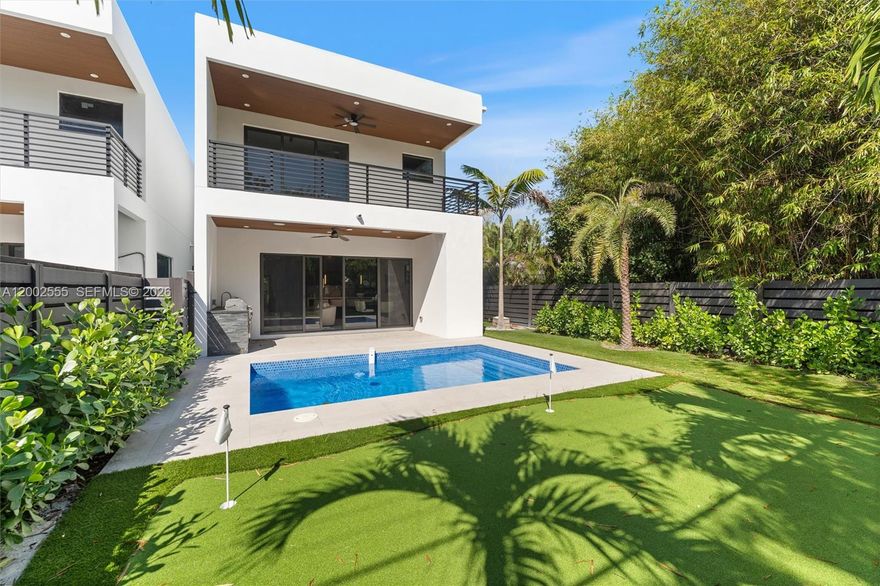 Exceptional new construction luxury townhome offering modern design, functionality, and lifestyle flexibility in a prime East Fort Lauderdale location just minutes from the beach, Las Olas, and downtown. This architecturally striking residence features 4 bedrooms and 4 full bathrooms, including a highly desirable first-floor bedroom—rare in townhome living. Designed to feel like a single-family home, it offers a spacious, wide two-car garage, open living areas, and seamless indoor-outdoor flow. A dramatic floating staircase creates a stunning focal point, while the chef’s kitchen is beautifully appointed with JennAir appliances, custom cabinetry, and sleek finishes. Upstairs, a versatile loft provides additional living space or can be converted into another bedroom, offering flexibility for families or guests. Large impact glass and private balconies enhance natural light throughout. The outdoor space features a resort-style pool, summer kitchen, professional landscaping, irrigation system, and a mini putting green—perfect for golf enthusiasts and entertaining. Smart home features include a pre-wired three-zone audio system, security cameras, Ring doorbell, and more. Ideal for end users, multi-generational living, or investors, with Airbnb potential, perfect for families or siblings wanting to be close while maintaining privacy.