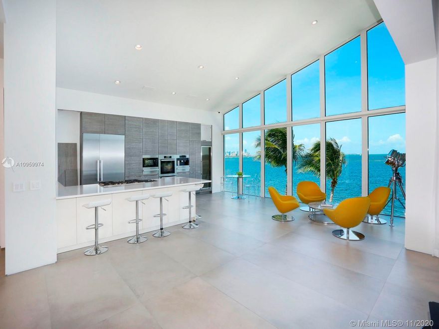 Contemporary home with dramatic unobstructed views of ocean and city skyline. Located in gated Sunrise Harbour, this 3 story home boasts high ceilings, voluminous living spaces and bedrooms with spacious walk-in closets, commercial elevator, pool and private dock with 100ft of deep water frontage.
