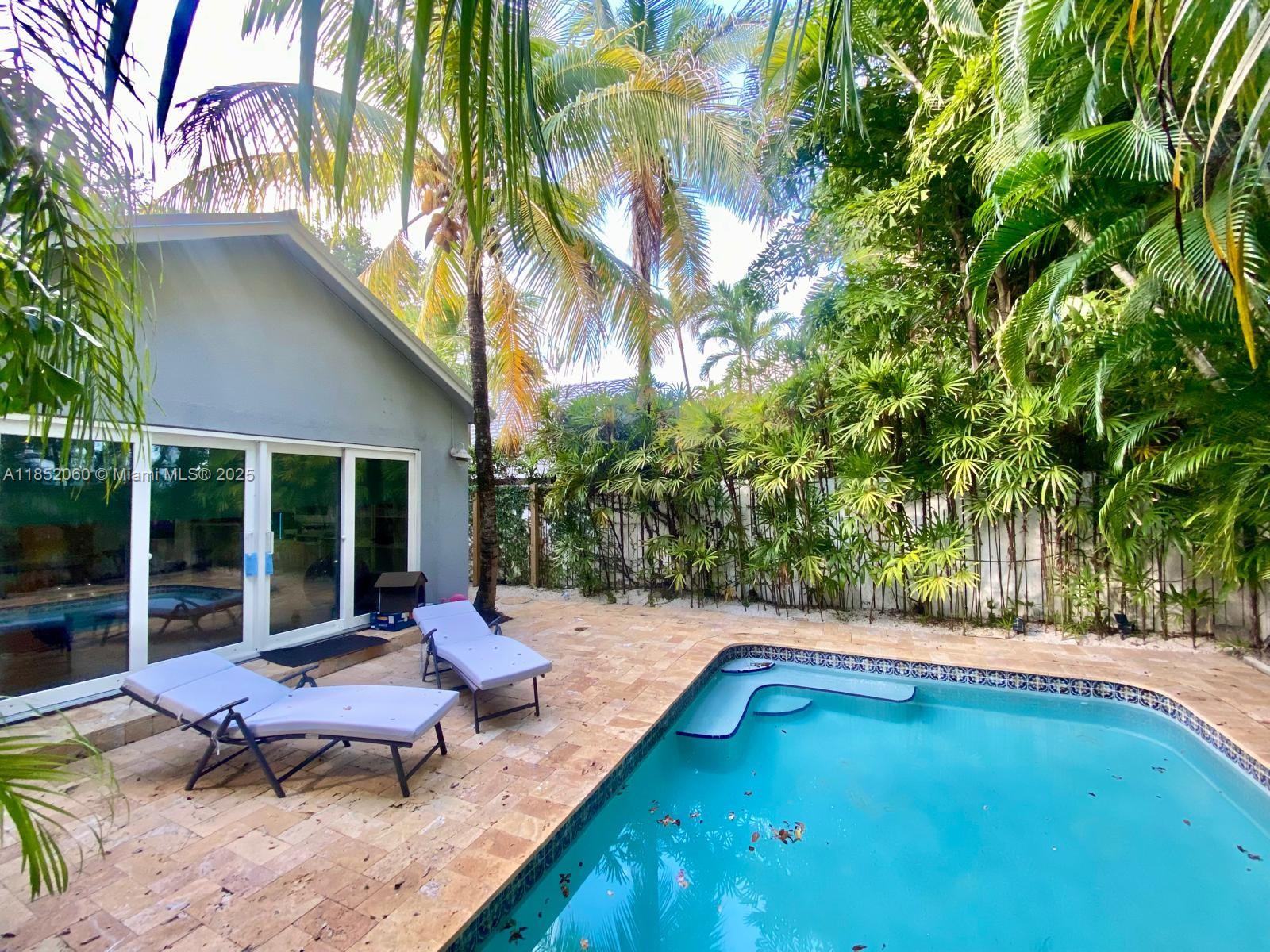 Discover this updated pool home tucked into a quiet North Coconut Grove cul-de-sac, your perfect retreat from the city’s hustle. Surrounded by lush tropical landscaping, the private pool offers a serene escape for relaxing or entertaining. The open-concept layout is filled with natural light and features impact windows. Enjoy a modern open kitchen with stainless steel appliances flowing into a spacious living area. Both bedrooms offer generous closet space, plus extra linen storage. A newer AC unit, lush landscaping, and a professional deep clean make it move-in ready. Includes outdoor storage, a responsive landlord, and a very dog-friendly environment. Big dogs welcome too! Fantastic location near Biscayne bay, Kenedy Park top schools and downtown Grove.