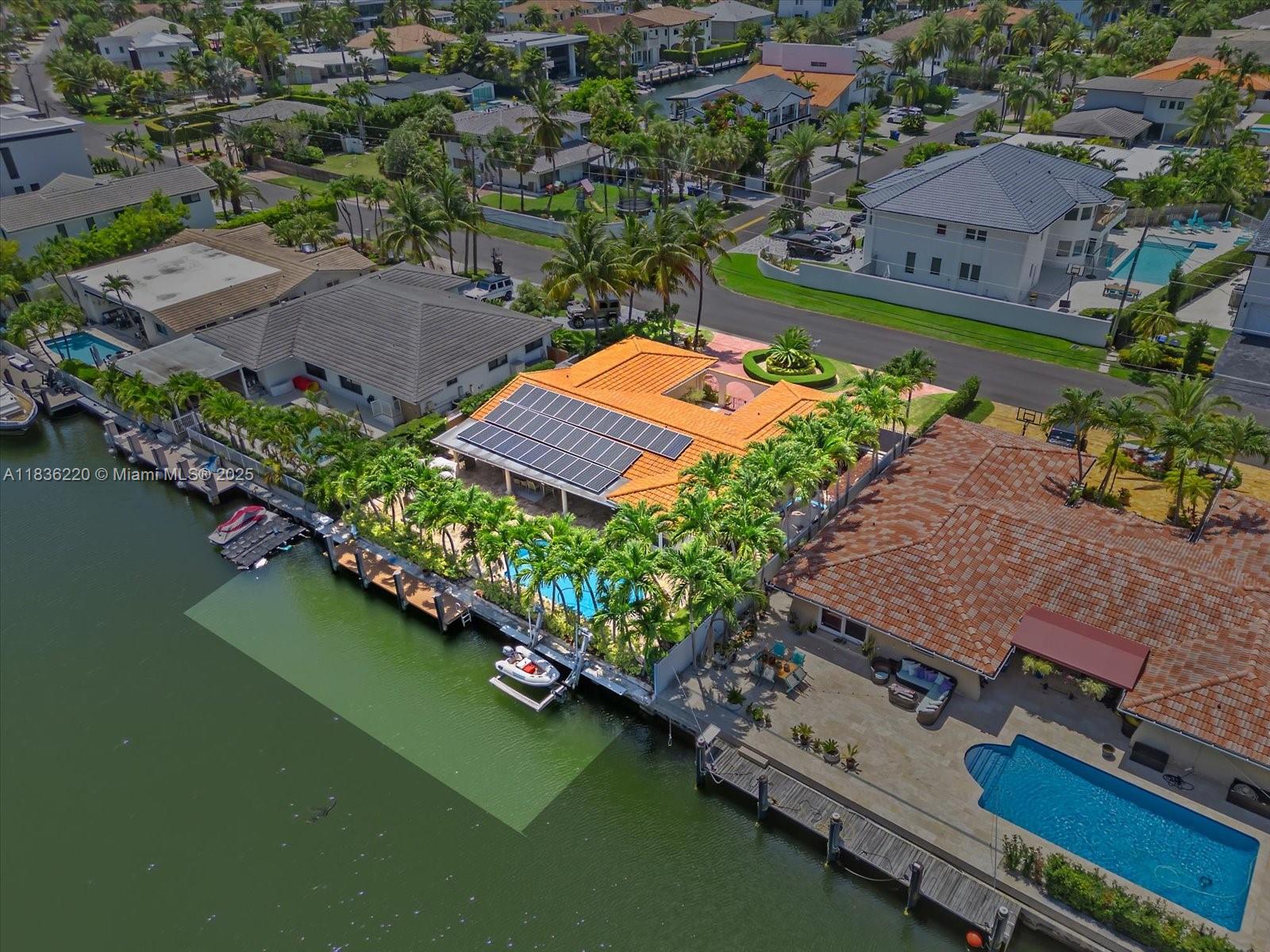 BEST DEAL IN TOWN! Experience the pinnacle of waterfront living at 3220 NE 164th St nestled in the prestigious, gated community of Eastern Shores. This 4 bedroom, 3 bathroom residence offers 80 feet of prime water frontage with direct ocean access. The home features an expansive light-filled floor plan that offers a bright open, and airy atmosphere throughout, highlighted by a luxurious primary suite with generous walk-in closets and a en-suite bathroom. The gourmet kitchen is outfitted with custom finishes and high end appliances. Step outside to your private outdoor retreat, complete with a heated pool, lush landscaping, and a private dock. Solar panels on the roof provide modern energy-efficient living. Near world-class beaches, dining and shopping this is waterfront elegance redefined!