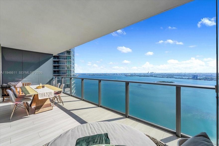 Beautifully redesigned with a refined, modern aesthetic, this professionally curated residence showcases distinctive luxury finishes best experienced in person. Enjoy sweeping panoramic views of Biscayne Bay, the Atlantic Ocean, and the Edgewater skyline from an oversized balcony . Thoughtful upgrades include custom lighting, reflective ceilings, striking 3D ribbed accent walls, textured Italian wallpaper, bespoke closets, ceramic oak flooring, and one assigned parking space. Resort-style amenities span a two-acre pool deck with a striking 100’ round pool, spas, tennis courts, and a state-of-the-art fitness center. Social and lifestyle spaces include club rooms, indoor and outdoor kitchens, cigar and wine rooms, game rooms, bowling alleys, and more.