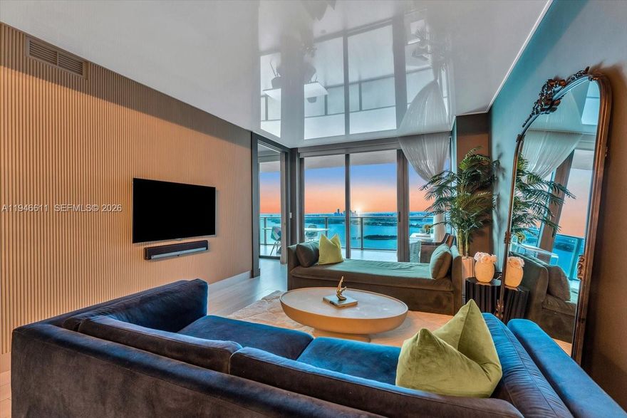 Option to purchase turnkey with furniture negotiable. Designer-styled unit, furniture was professionally curated for the space. Easiest move-in option in the building. Modern aesthetic and distinctive luxury finishes best experienced in person. Enjoy sweeping panoramic views of Biscayne Bay, the Atlantic Ocean, and the Edgewater skyline from an oversized balcony. Thoughtful upgrades include reflective ceilings that make the space feel bigger, custom mood lighting, striking 3D ribbed accent walls, textured Italian wallpaper, bespoke closets, Italian porcelain white oak-wood-look flooring, and one assigned parking space. More resort-style amenities than in surrounding buildings - a two-acre pool deck with a striking 100’ round pool, spas, tennis courts, bowling alley and a state-of-the-art fitness center. Social and lifestyle spaces include club rooms, indoor and outdoor kitchens, cigar and wine rooms, game rooms, barbecue areas, putting green, golf simulator, FREE daily fitness classes, and more.