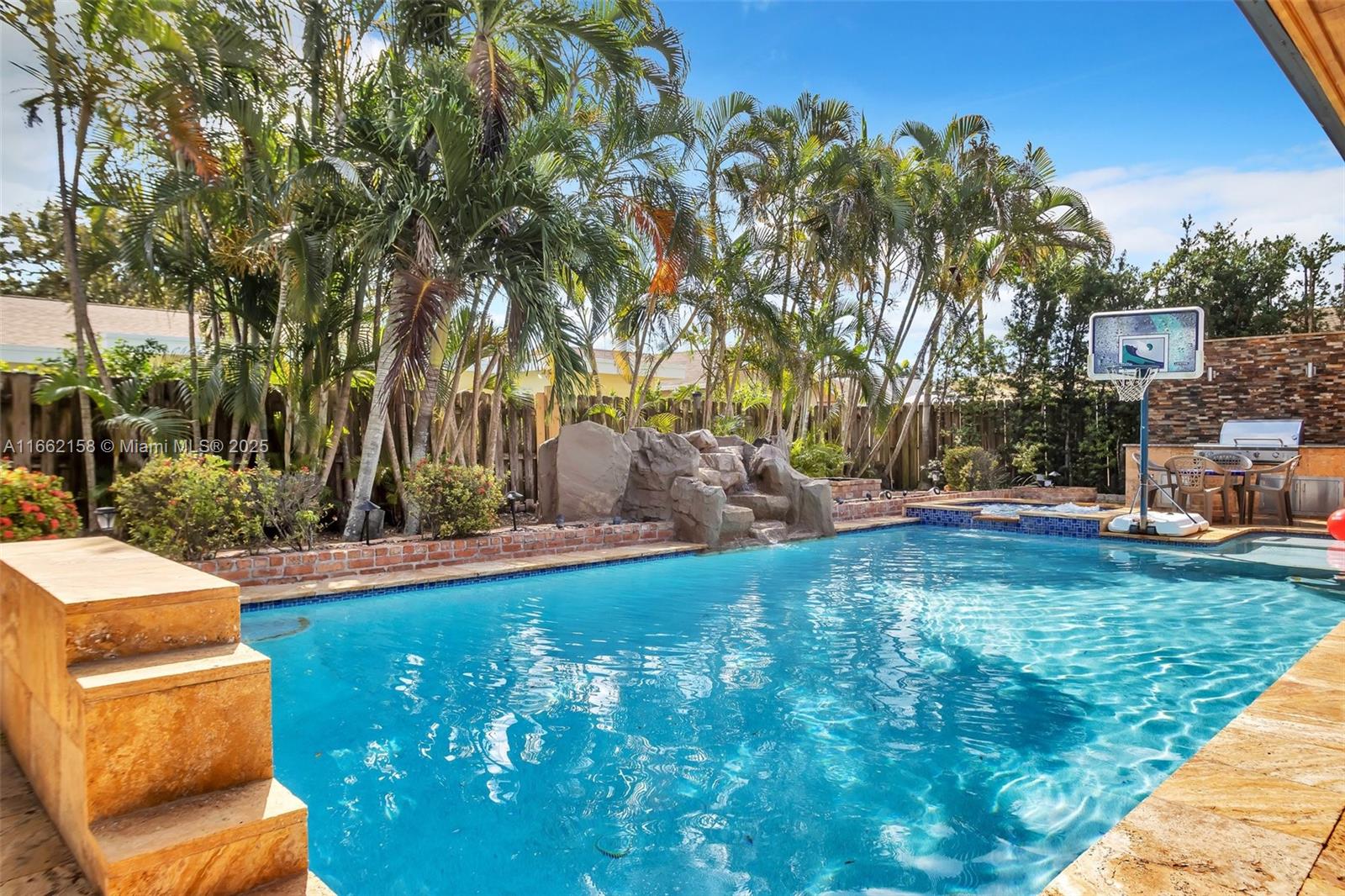 $150,000 IN UPGRADES IN BACKYARD ALONE! Discover this stunning 4-bed, 2-bath home, designed to bring your outdoor living dreams to life. The expansive, covered patio is perfect for year-round entertaining, featuring a cozy fireplace, bar seating, and a unique pass-through window to the kitchen, making it easy to serve drinks and snacks while keeping the party going. Take a dip in the gorgeous heated saltwater pool or relax in the built-in spa, both with a new heating system that ensures comfort no matter the season. Fire up the built-in grill for al fresco dining, and as the sun sets, gather around the firepit for cozy evenings under the stars. With a new roof and AC system, plus a spacious garage, this home is built for convenience and designed for endless outdoor fun.