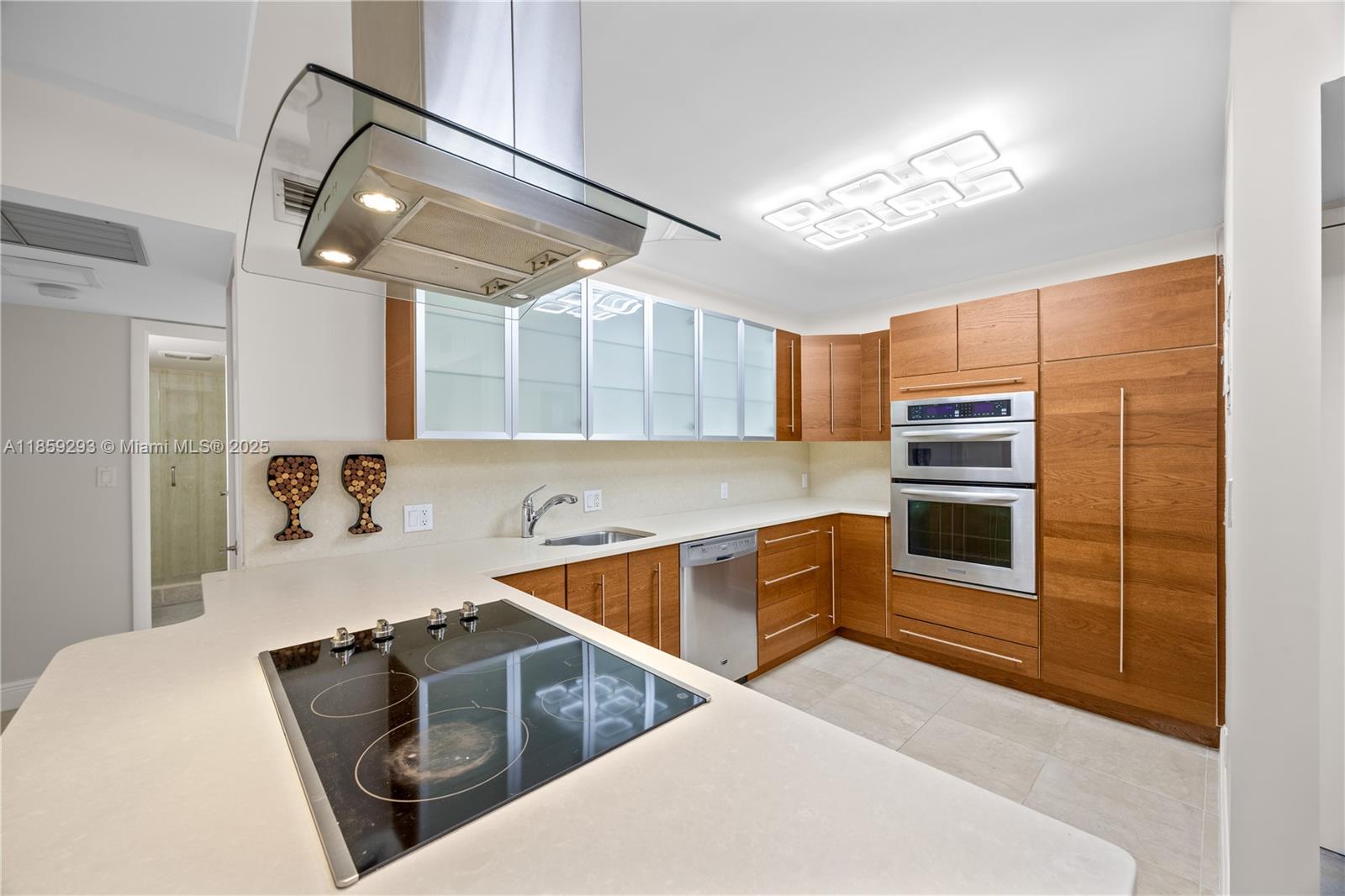 Step into this beautifully remodeled corner unit, where modern style meets comfort. The European-style kitchen features sleek custom cabinetry, stainless steel appliances, and brand-new range and refrigerator. Fresh paint, new motorized blinds, and top-quality impact windows and sliding doors add both beauty and security. The split bedroom plan offers privacy, with two spacious rooms and a brand-new custom bathroom designed for a luxurious feel. A covered garage parking space and storage unit are included. Located in a gated community with 24-hour security, the building has a newly updated lobby, a resort-inspired pool, and a fitness center. Surrounded by the greens of the prestigious Marriott Turnberry Resort and just a short stroll to Aventura Mall