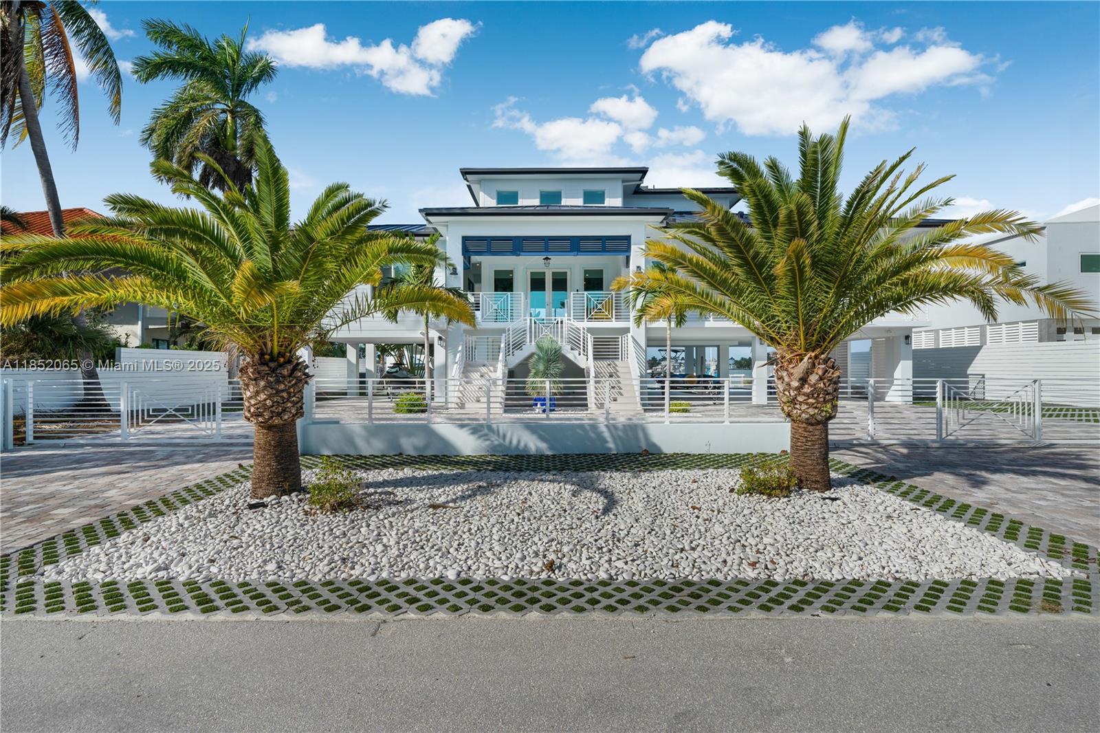 Welcome to your waterfront paradise! Solid concrete, newly built 4-bed, 4.5-bath home offers luxury finishes designed for modern coastal living. The chef's kitchen features state-of-the-art appliances & an open layout flowing seamlessly into the spacious living/dining areas. The balconies offer beautiful views & include a summer kitchen for outdoor dining & entertaining. The master suite is a private oasis on its own floor, complete w/a sun deck, walk-in closets, & a large balcony perfect for relaxation. W/a 100-foot seawall, 25,000 lb boat lift & boat, & a floating dock & jet skis, this property is an ideal base for water enthusiasts. Relax in the heated pool or enjoy the thoughtfully designed outdoor spaces for cooking & lounging—just 20 minutes from Key West & 15 minutes from Marathon.