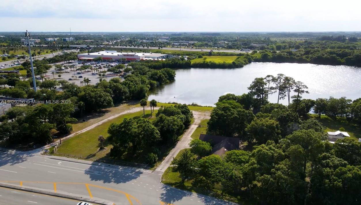 Secure this versatile 3-acre lot featuring lake access, 3 storage bays and a single-family home perfect for trailer storage, logistic operations, or live/work setup. Just minutes from major corridors and next to Home Depot and Sonic. Property Highlights: 3 Bays for storage or enclosed operations and 2 electrical meters for flexible tenant use. Two entrances for efficient truck circulation and access control. Zoned CG (Commercial General) - allows heavy duty parking flat, cleared lot with ample room for semi-trucks, containers, and equipment. Lake frontage offers drainage benefits and unique aesthetic value on site 3 bedroom/1 bathroom home with screened-in back porch - ideal for onsite staff or owner use.