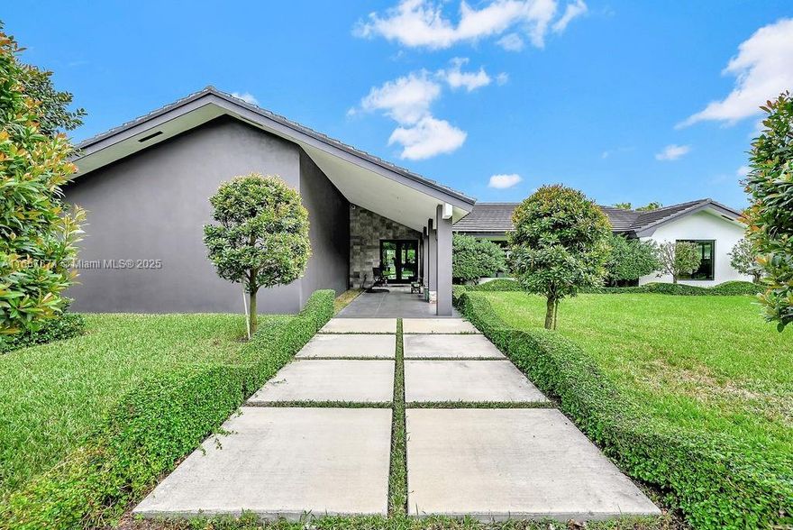 Constructed 2021, 3,537 sq. ft. home gracefully nestled on a sprawling builder's acre within a secure cul-de-sac gated lot. This residence boasts 5 spacious BR/5 elegantly designed BA, adorned with 24x 24 Italian tile that adds a touch of sophistication throughout. The interior impresses with vaulted high ceilings, contemporary bathrooms, and a gourmet kitchen equipped with stainless steel Jenn-Air appliances, with a beautiful stone countertop, perfect for your culinary creations. Enjoy the luxury of an in-home theater and an abundance of natural light streaming through the numerous windows. Step outside to a covered, expansive patio that seamlessly transitions to a 40ft x 20ft saltwater pool surrounded by a travertine deck, ideal for both relaxation and entertaining.