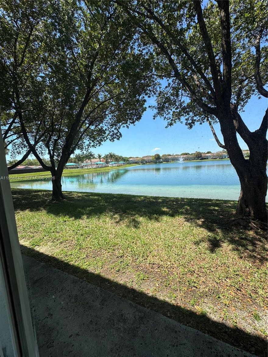 Wonderful, unique, and impeccable townhome with lake views!

This beautiful residence features 3 bedrooms plus an enclosed fourth bedroom, offering flexibility for a guest room, office, or additional living space.

Located in an elegant gated community with 24-hour security, enjoy a lifestyle surrounded by two lakes and a pool, perfect for comfortable family living. Ideally situated across the street from Publix and just minutes from major highways, providing convenience at your doorstep.

The home is in move-in ready condition, with over $10,000 in upgrades, including stainless steel appliances, washer and dryer, wood floors, and bright, inviting spaces throughout.

Relax in your private lakefront backyard, ideal for enjoying peaceful views and outdoor living.

The perfect home to live and enjoy with your family — or a great investment opportunity.

With an FHA loan, your monthly mortgage could be similar to your rent — making this your opportunity to finally own your dream home. FHA-approved community.