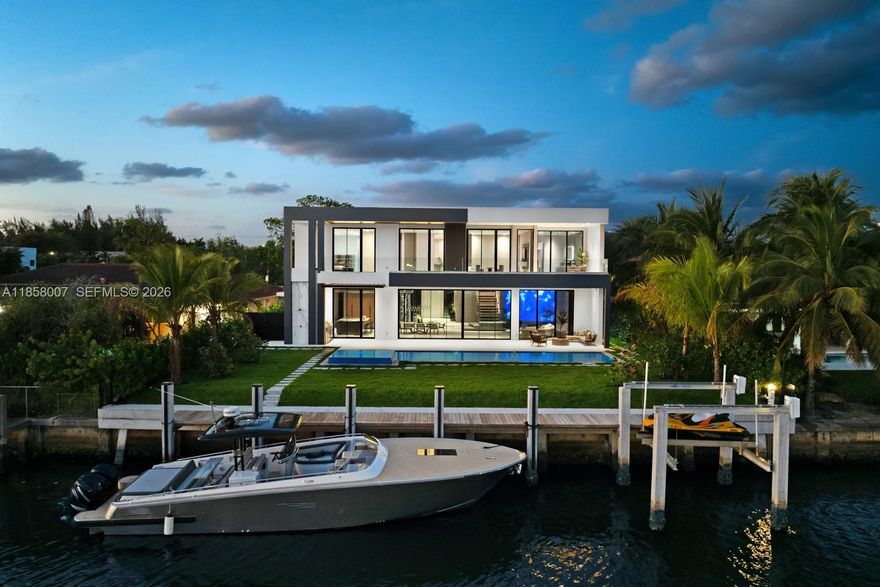 Crafted by Barreto Constructions, this 2024 new-construction waterfront estate presents a rare opportunity within the gated enclave of Golden Isles. Offering 9,536 total sq. ft., 85 feet of canal frontage, and direct ocean access with no fixed bridges, the residence combines architectural presence with immediate lifestyle execution.
Designed with 11-ft ceilings and expansive open living spaces, this 6BD/6BA/2HB contemporary home features a Mia Cucina Italian marble kitchen, integrated smart home and smart glass systems, premium sound, dual coffee stations, and a 160+ bottle temperature-controlled wine cellar.
Outdoor living is elevated with a resort-style pool and spa, covered terrace, summer kitchen with draft beer system, and upper-level wet bar. A newly constructed seawall built to current code and private dock enhance long-term waterfront integrity.
Additional highlights include a rare 979 SF climate-controlled collector’s garage within a 4-car configuration, Laundry Jet system, steam/dry-cleaning station, and 1,494 SF of finished terraces and balconies.
Fully completed and move-in ready, the property is strategically positioned among the Most Competitive 2024 new-construction waterfront offerings in Golden Isles—one of South Florida’s finite guard-gated boating communities with parks, dog parks, tennis courts, Minutes from beaches, golf, and Aventura Mall.