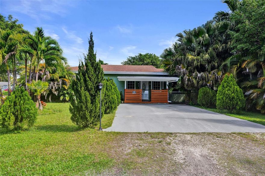Don't miss this unique East Davie gem! Situated on a private, fully fenced 1/2-acre corner  lot with no HOA, you’ll have the freedom to park your boat/RV, build a pool, or simply enjoy the space. The home features two separate living areas each with its own kitchen, 2 bedrooms, and 2 baths perfect for multi-generational living or rental potential. With two driveways, a corner lot, and access from a quiet dead-end street, this property offers both convenience and privacy. Minutes from major highways, it’s a rare find. Schedule your showing today!