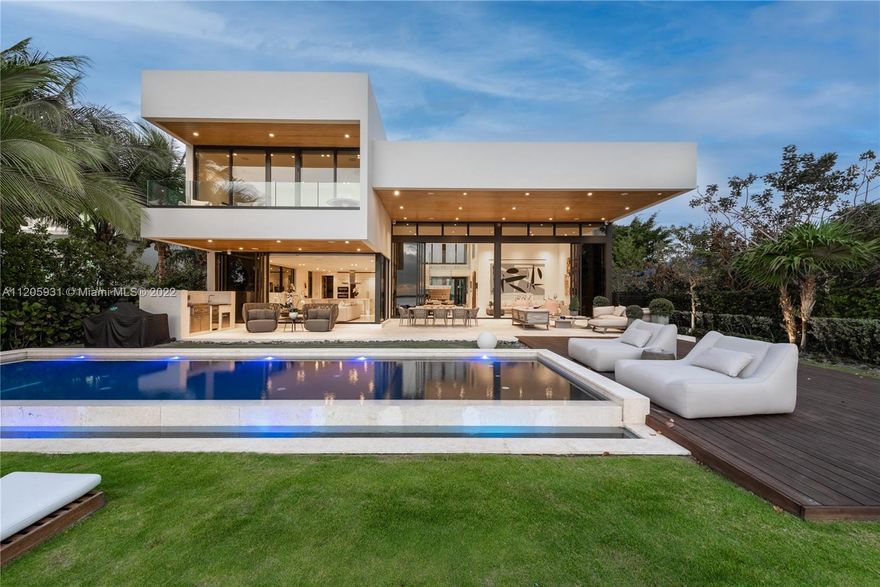 New modern waterfront with a western exposure capturing unobstructed water views and dramatic sunsets over Biscayne Bay! Situated on a 12,052-SF bayfront lot across Normandy Shores Golf Club, this luxe home offers an ideal lifestyle for golfers and boaters! Stunning contemporary living areas have soaring ceilings and sliding doors that open wall-to-wall creating a seamless connection between the interiors and exteriors. Home features gourmet kitchen, media room, elevator, ELAN smart control system, floating glass staircase, and a waterfront master suite with a private terrace, walk-in closet, and luxe bath. The expansive backyard is equipped with a covered patio for dining and lounging, pool, and a pier dock with a boat lift by the 73-FT of waterfrontage. Gated home with a 2-car garage.