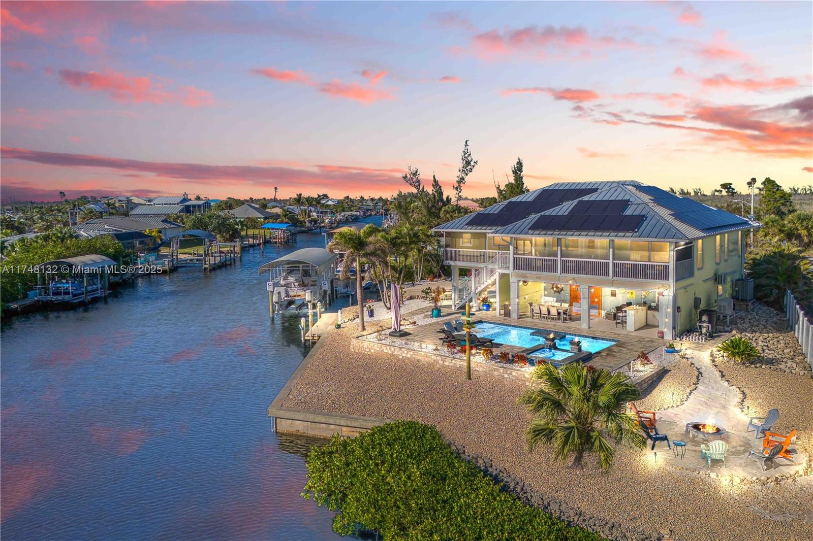 When Margaritaville meets Luxury - this home is magnificent and one of a kind - located on a corner oversized lot with intersecting canals AND at the end of a cul-de-sac with easy access out to open water! No stone unturned - pure luxury - from the Amish built cabinets, to the custom touches throughout, this home has been completely remodeled with no expense spared! Lets start with the downstairs! There is a three car garage with an additional bay as well as fully airconditioned office/flex room, AND a full bathroom - also with its own air conditioner (all new). Additional four car carport for all your parking needs! With tall ceilings, this is a dream garage and so incredibly flexible with the layout! Double doors with custom port holes then lead you to the outdoor RESORT OASIS!