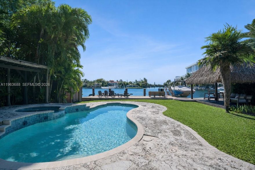 Situated on the widest stretch of Surprise Lake in the heart of Lakeview, this oversized 14,140 SF waterfront property offers expansive open water views, direct ocean access, a private dock, pool, and expansive backyard designed for boating, entertaining, and everyday outdoor living, a true boater’s paradise.
The four-bedroom residence features bright interiors with strong natural light, well-proportioned bedrooms, and comfortable living spaces that open seamlessly to the water. Large windows and effortless indoor-outdoor flow create an airy, light-filled environment throughout. The primary suite overlooks the lake and features a spacious bathroom, offering a private waterfront retreat. A sunlit kitchen equipped with Wolf appliances anchors the home, opening to comfortable living and dining areas ideal for gatherings and daily family life. The layout supports effortless living today, with the ability to elevate and modernize over time to reflect your own design vision.
Lakeview is one of Miami Beach’s most established and desirable neighborhoods, known for tree-lined streets, a strong sense of community, proximity to top schools and parks, and convenient access on and off the Beach. Enjoy the home as is, update to your taste, or design a custom waterfront estate that fully maximizes this exceptional lot and premier location.