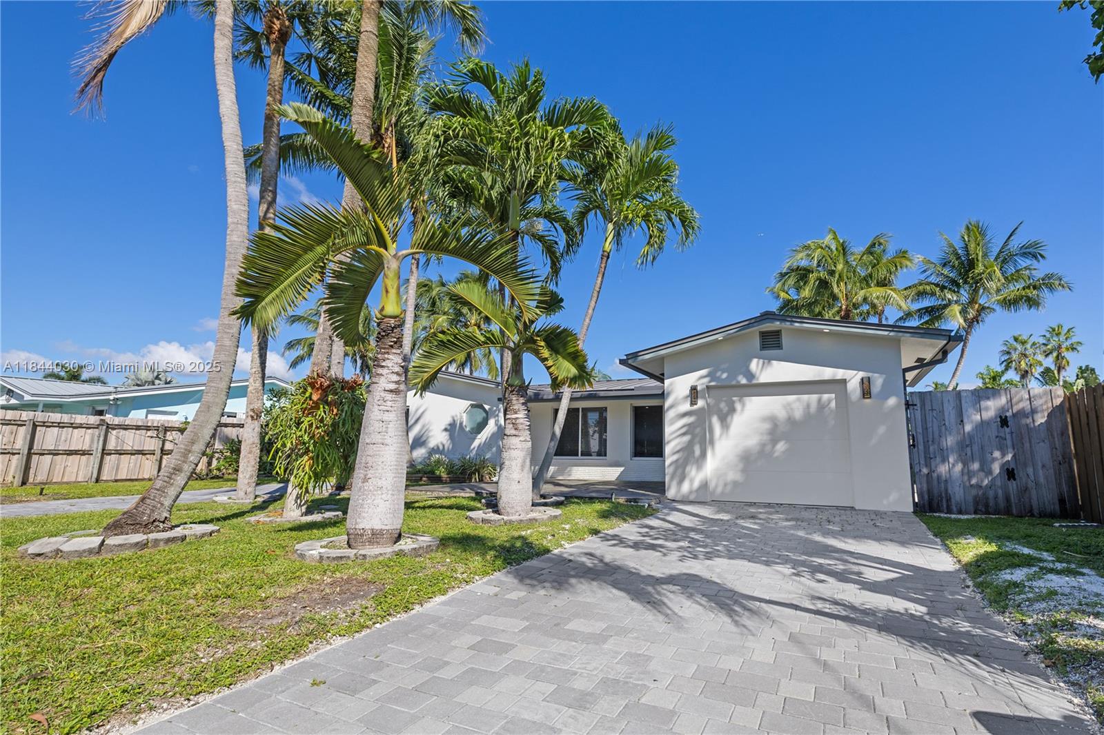 Discover this beautifully renovated 3-bedroom, 2-bath waterfront home with no fixed bridges and direct ocean access — just minutes from downtown Fort Lauderdale, the airport, and the beaches. The house has a 2024 metal roof with high impact windows and doors. Enjoy your own 60 ft dock, plus a heated pool and spa for year-round enjoyment. Inside, you'll find porcelain tile floors and recessed lighting throughout. The open-concept layout is flooded with natural light, and both the kitchen and living room overlook the pool canal. The spacious kitchen features granite countertops, stainless steel appliances, and room for a cozy breakfast nook. There's also a dedicated dining area for entertaining guests. The 1-car garage is ideal for a golf cart, motorcycles, bikes, or extra storage.