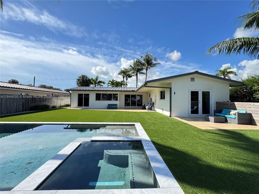 Discover this beautifully renovated 3-bedroom, 2-bath waterfront home with no fixed bridges and direct ocean access — just minutes from downtown Fort Lauderdale, the airport, and the beaches. The house has a 2024 metal roof with high impact windows and doors. Enjoy your own 60 ft dock, plus a heated pool and spa for year-round enjoyment. Inside, you'll find porcelain tile floors and recessed lighting throughout. The open-concept layout is flooded with natural light, and both the kitchen and living room overlook the pool canal. The spacious kitchen features granite countertops, stainless steel appliances, and room for a cozy breakfast nook. There's also a dedicated dining area for entertaining guests. The 1-car garage is ideal for a golf cart, motorcycles, bikes, or extra storage.